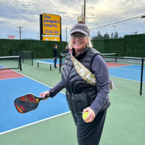 Susie holding a racquet at a pickleball court