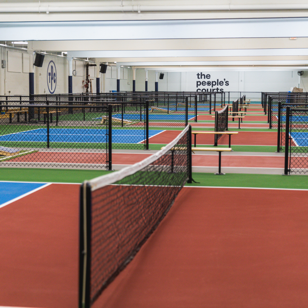 Interior of a large building that has several pickleball courts