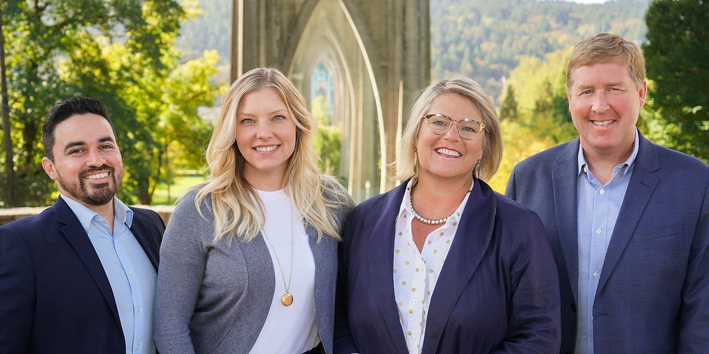 4 Portland real estate agents standing in front of a bridge